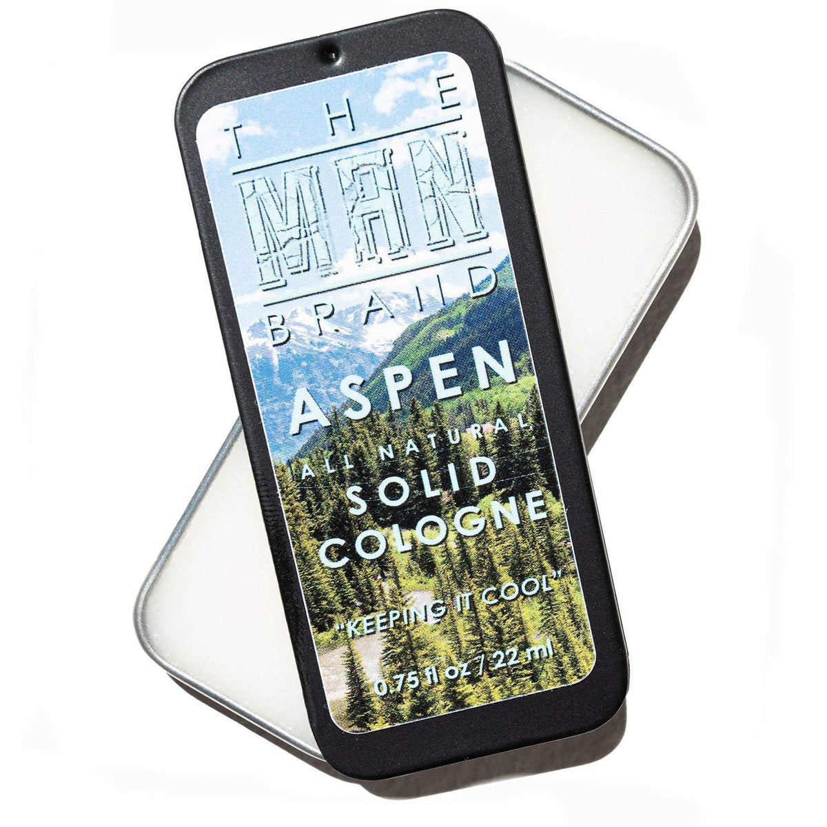 Aspen Solid Cologne in a black slide tin, with a colorful mountain and evergreen forest label and white lettering.