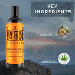 Business As Usual Body Lotion in a dark bottle with a bright orange label featuring black text and an aloe vera and shea butter graphic.