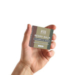Cedarwood Blend Beard Balm in a small olive green and brown rectangular tin with white lettering and a screw-top lid.