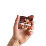 Solid cologne in a clear square tin, with an amber bourbon-patterned label and “Gentlemen's Bourbon” branding.