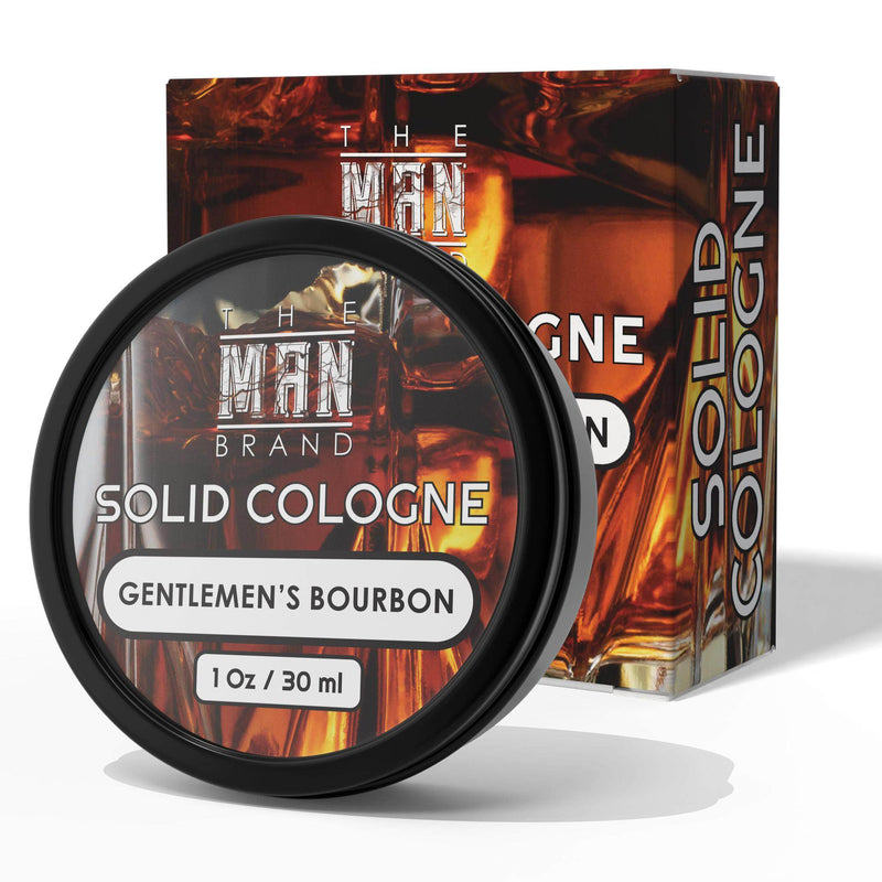 Solid cologne labeled Gentlemen's Bourbon, in a round black tin with a fiery amber whiskey-inspired label and matching box.