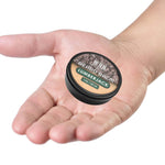 Lumberjack Beard Balm in a small round black tin, with a brown woodgrain label and green accent band.