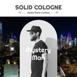 Mystery Man Solid Cologne label featuring a black-and-white portrait of a bearded man in a cap and sunglasses.
