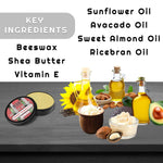 Sweet Tobacco Beard Balm in a black tin beside pale yellow balm, with illustrated natural oil, beeswax and shea butter ingredients.