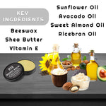 Unscented Beard Balm in a black round tin beside a yellow balm, with ingredient oils and butters pictured.